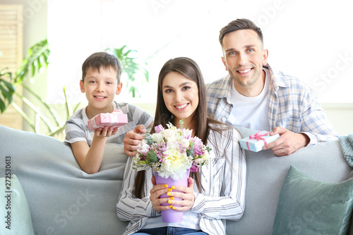 Family greeting young woman...