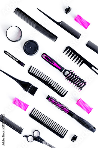 Fototapeta Naklejka Na Ścianę i Meble -  Set of professional hairdresser tools with combs and sciccors on white background top view pattern