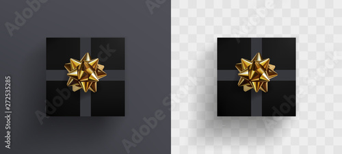 Decorative black gift box with realistic glittering golden bow