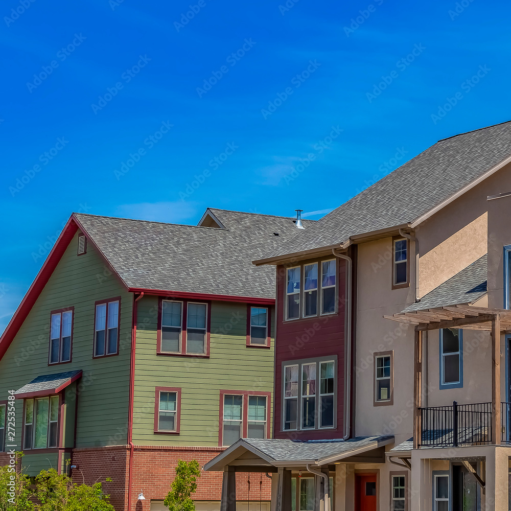 Square frame Exterior view of houses with vast blue sky background on a sunny day