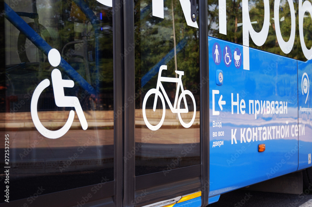 Φωτογραφία City electric bus, glass doors and side view with icons for disabled person, bicycle, elderly person and pram