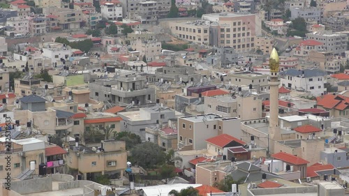 Skyline of Umm El Fahm zoom, an Arab town with citizens of Israel. Umm al-Fahm is the social, cultural and economic center for residents of the Wadi Ara and Triangle regions. photo