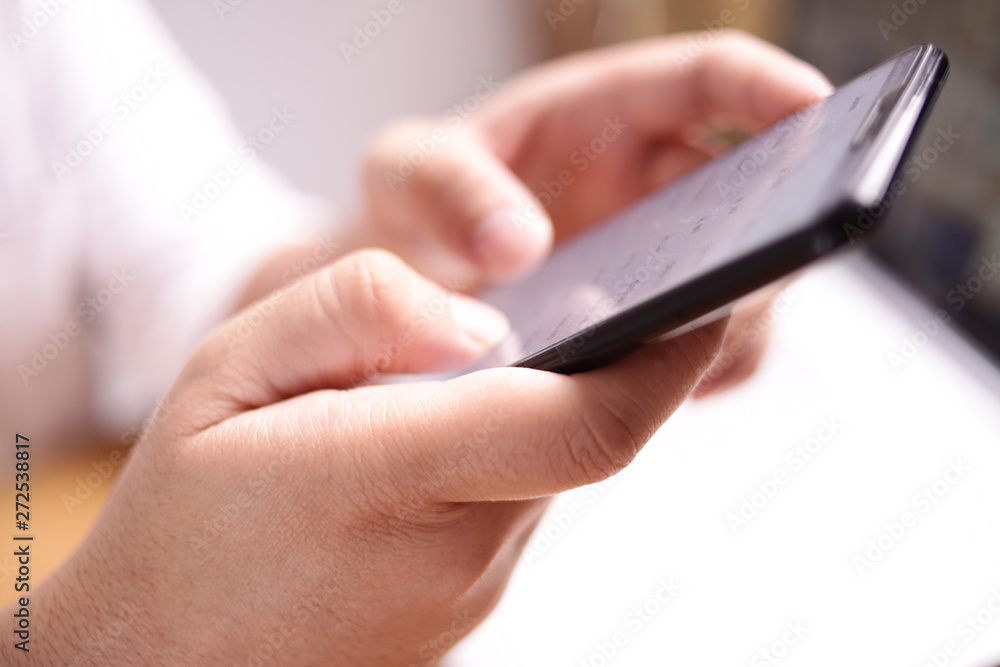 Businessman Holding and Using Smart Phone Businessman Holding and Using Smart Phone