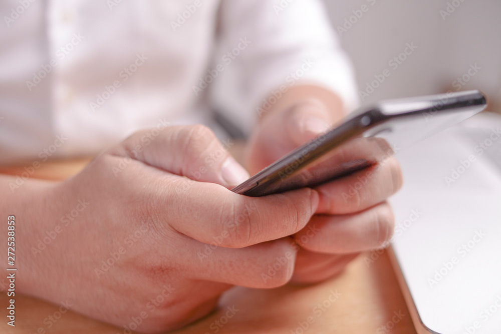 Businessman Holding and Using Smart Phone Businessman Holding and Using Smart Phone
