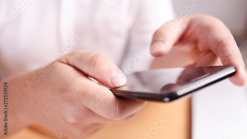 Businessman Holding and Using Smart Phone