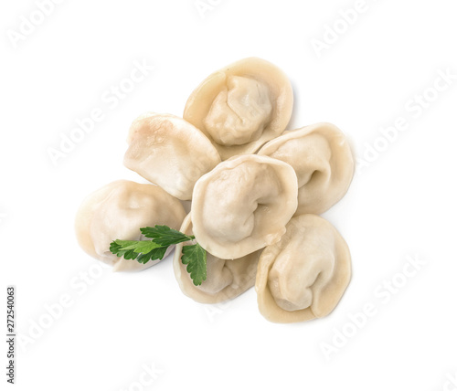 Pile of boiled dumplings with parsley leaves on white background, top view