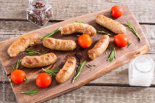 Grilled sausages with tomatoes , pepper and rosemary