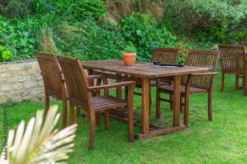 Chairs and tables set up in the garden for the simmer time in the UK.