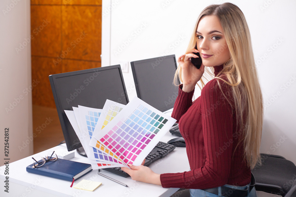 Portrait Of Happy Young Businesswoman Sitting At Desk While Working Portrait Of Happy Young Businesswoman Sitting At Desk While Working