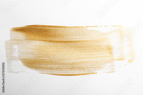 Strokes of gold paint isolated on white, top view