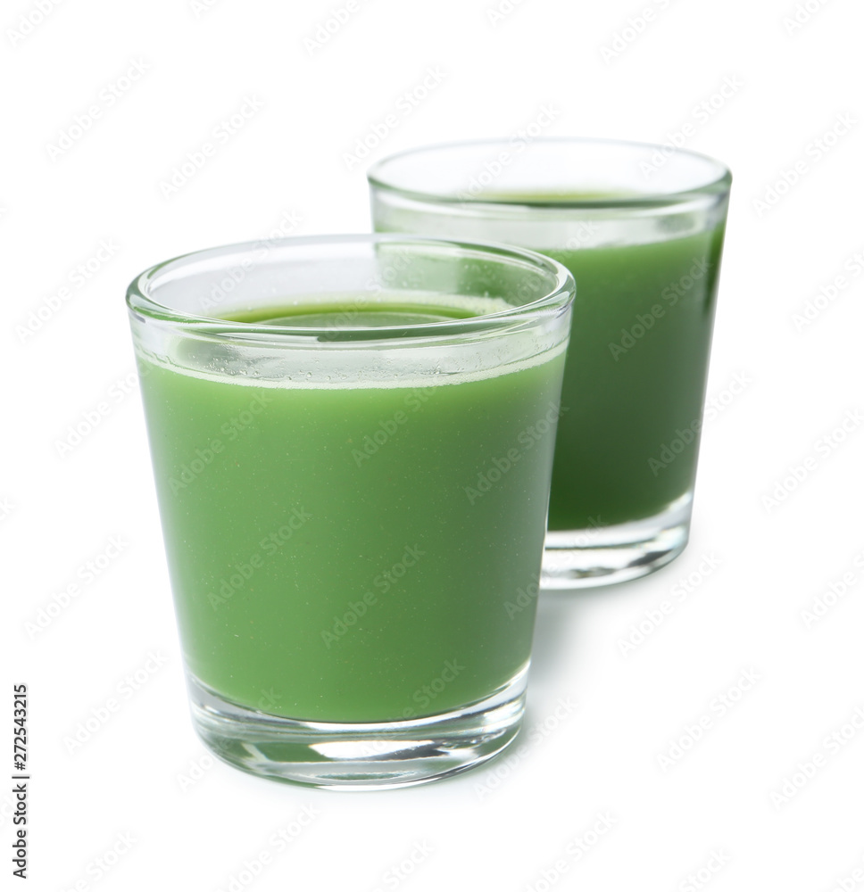 Fresh wheat grass juice in glasses on white background Fresh wheat grass juice in glasses on white background