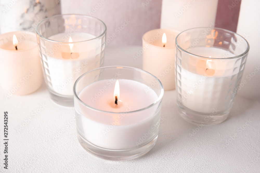 Burning aromatic candles in holders on table Burning aromatic candles in holders on table
