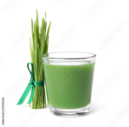 Glass of fresh wheat grass juice and sprouts on white background