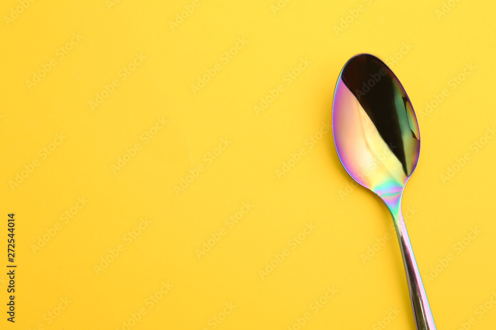 Clean tea spoon and space for text on color background, top view Clean tea spoon and space for text on color background, top view