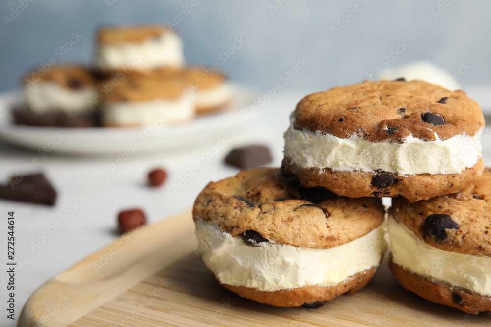 Sweet delicious ice cream cookie sandwiches on table, closeup. Space for text