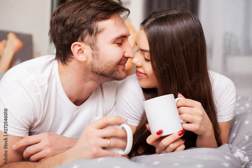 Happy couple having fun in bed. Intimate sensual young couple in bedroom enjoying each other Happy couple having fun in bed. Intimate sensual young couple in bedroom enjoying each other