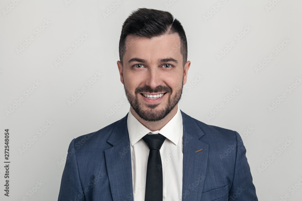 Closeup Portrait of a handsome businessman smiling at the camera. dressed in a suit. Isolated on a white background Closeup Portrait of a handsome businessman smiling at the camera. dressed in a suit. Isolated on a white background