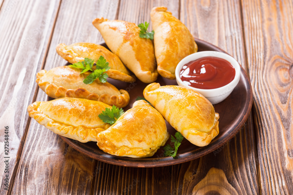 Latin American baked beef empanadas with sauce Latin American baked beef empanadas with sauce