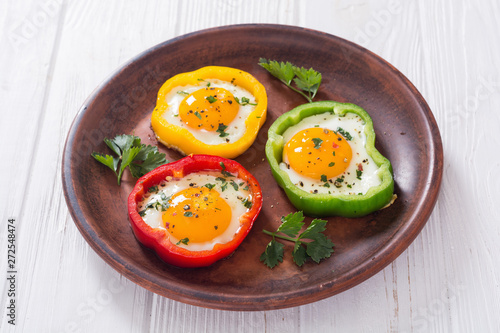 Yellow   red and green pepper with fried eggs