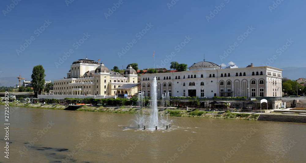 Skopje cityscape with the famous Skopje citadel and the Kale fortress reflecting in the water of the Vardar river on a sunny summer day in Macedonia capital city in the Balkans.