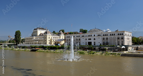 Skopje cityscape with the famous Skopje citadel and the Kale fortress reflecting in the water of the Vardar river on a sunny summer day in Macedonia capital city in the Balkans.