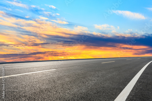 Asphalt road and sunset sky