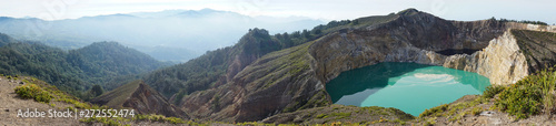 Panorama of kelimutu lake in Kelimutu Flores-Indonesia national park on a clear day. Lake water is turquoise and black green