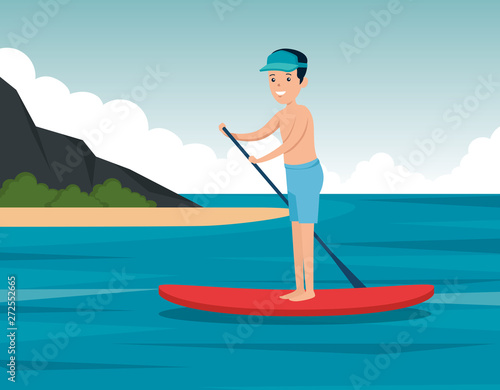 boy training paddle board in the landscape