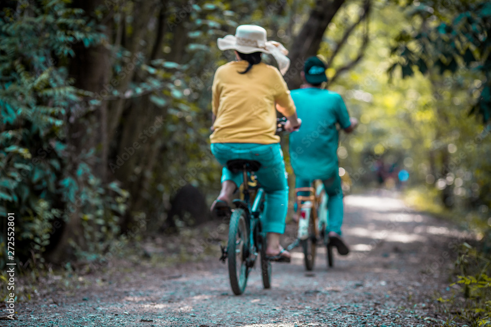 Blurred background of people who are cycling fast, exercising in the park in the morning - evening, the atmosphere is surrounded by nature. Blurred background of people who are cycling fast, exercising in the park in the morning - evening, the atmosphere is surrounded by nature.