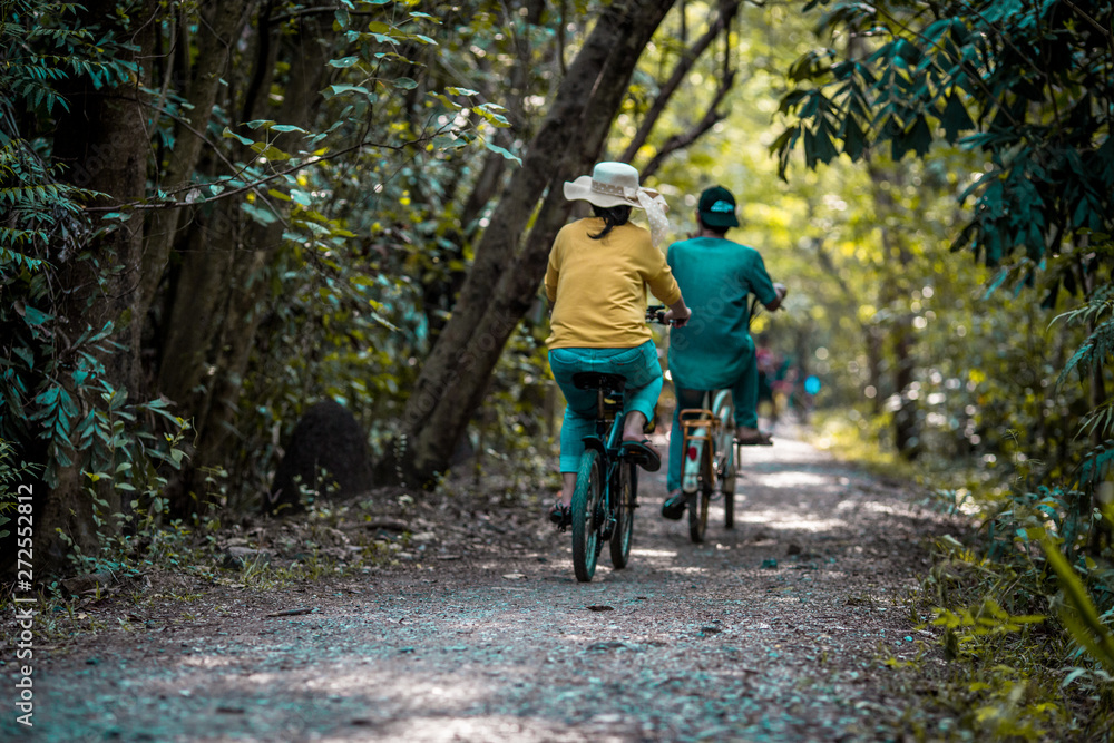 Blurred background of people who are cycling fast, exercising in the park in the morning - evening, the atmosphere is surrounded by nature.