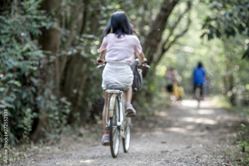 Blurred background of people who are cycling fast, exercising in the park in the morning - evening, the atmosphere is surrounded by nature.