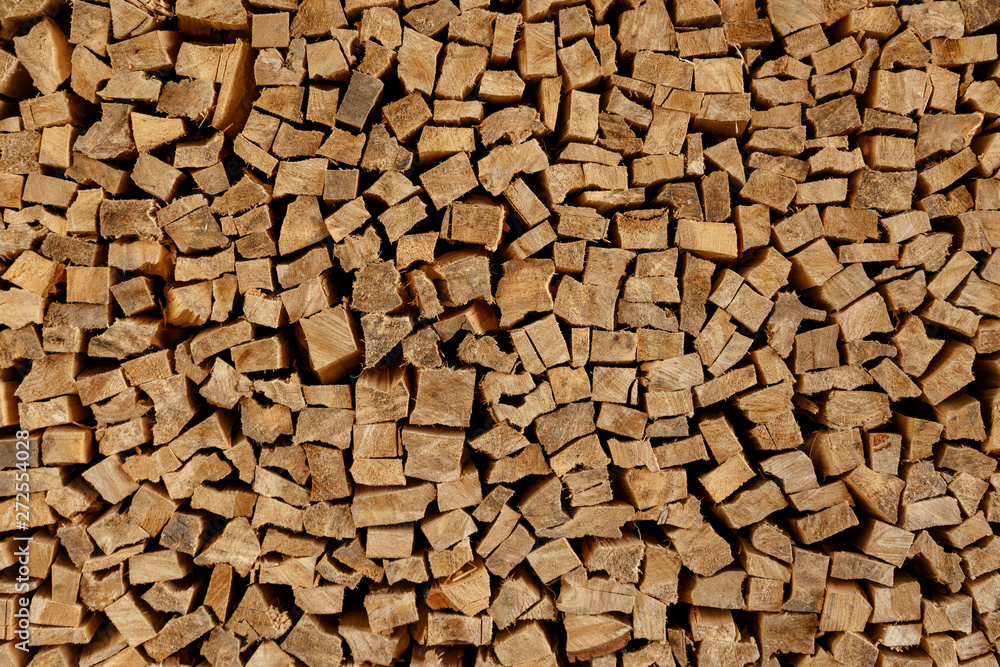 The texture of wooden firewood, randomly split and laid in straight rows The texture of wooden firewood, randomly split and laid in straight rows