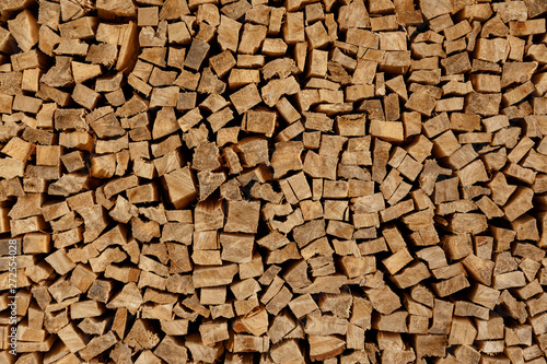 The texture of wooden firewood  randomly split and laid in straight rows