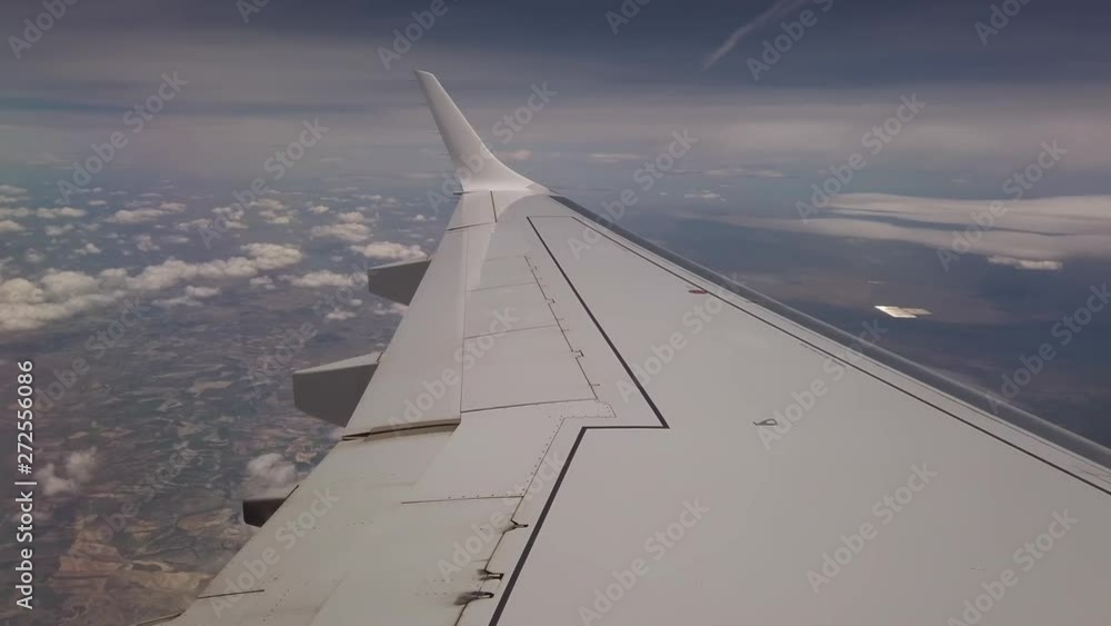 Airliner wing by day of good weather with some clouds Airliner wing by day of good weather with some clouds