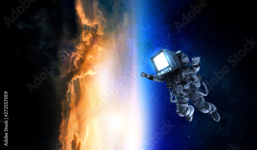 Fototapeta Naklejka Na Ścianę i Meble -  Astronaut with TV head in space. Mixed media.