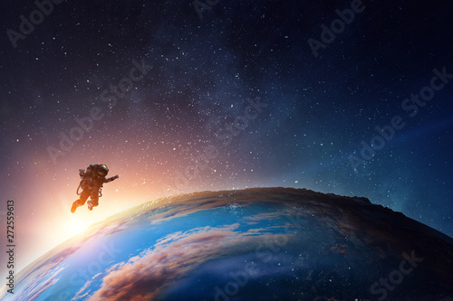 Astronaut in space on planet orbit. photo