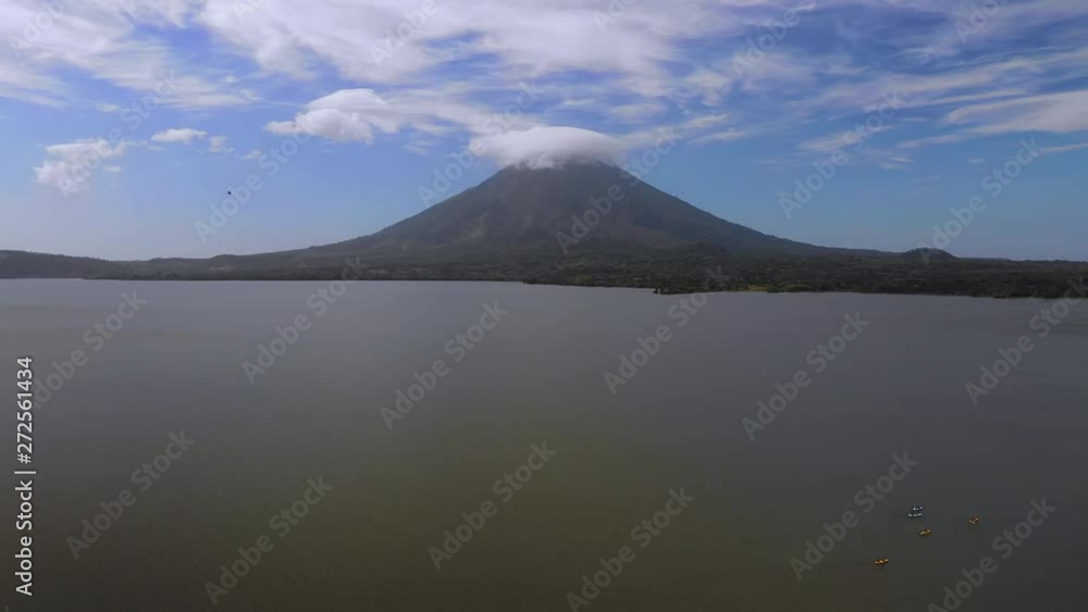 Aerial Exit: Trees On Edge Of Ocean With Volcano, Smoke On Opposite Side - Ometepe, Nicaragua Aerial Exit: Trees On Edge Of Ocean With Volcano, Smoke On Opposite Side - Ometepe, Nicaragua