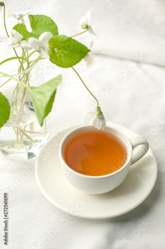 Wallpaper Mural Rural abstract background with cup of tea, vase and spring white flowers. Rustic scene, minimal still life Torontodigital.ca