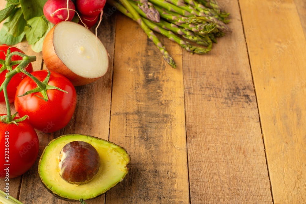 Fresh vegetables on wooden background. View from above. Vegetarian sets. Harvest. Gastronomy. Avocado. Asparagus. Tomatoes. Carrot Fresh vegetables on wooden background. View from above. Vegetarian sets. Harvest. Gastronomy. Avocado. Asparagus. Tomatoes. Carrot