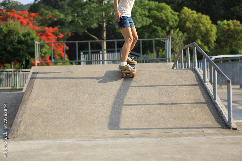 skateboarder legs skating at skatepark