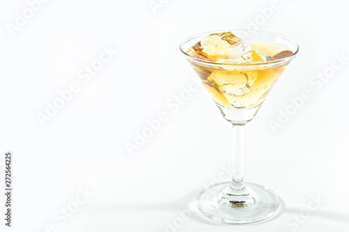 Alcohol drink with ice cubes isolated on white background.