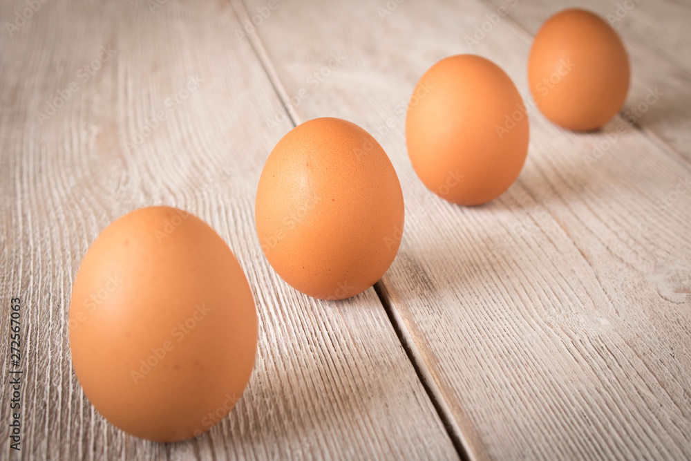Chicken eggs on a wooden table. Selective focus. Chicken eggs on a wooden table. Selective focus.