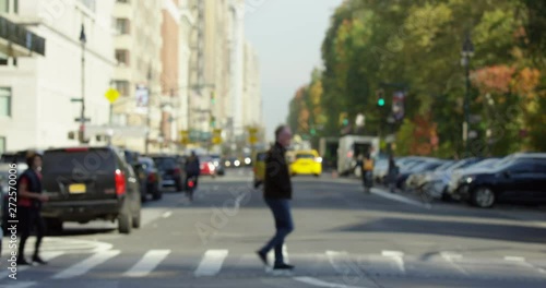  Blurred Focus Of Classic Yellow NYC Cabs On Busy Street In New York City ,Rush Hour Traffic,Manhattan. People Walking Along Street Exploring The City.  On A Sunny Day. 