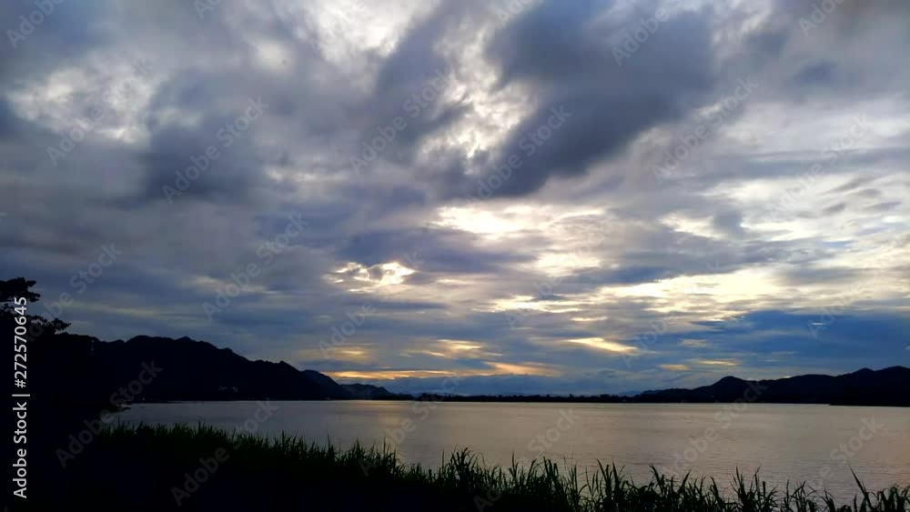4K Timelapse of clouds moving with the explosion of beautiful colors in the sky and reflections on the river. 4K Timelapse of clouds moving with the explosion of beautiful colors in the sky and reflections on the river.
