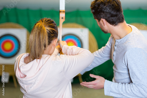 Obraz na plátně rear view of woman aiming at archery target