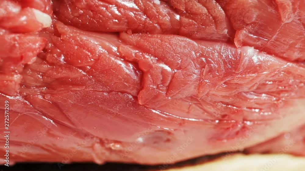 Macro shot of beef sirloin, fresh raw meat, filet mignon. Slow pan. Selective focus. Extreme close-up. Macro shot of beef sirloin, fresh raw meat, filet mignon. Slow pan. Selective focus. Extreme close-up.