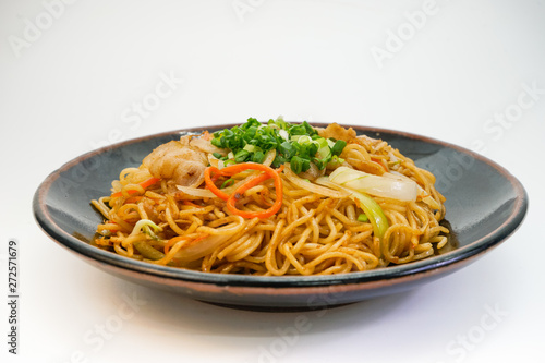 Plate of fried noodle with pork meat on white background   Asian Spaghetti