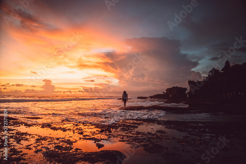 Lonely girl watching the sunset in Tanah Lot temple in Bali, Indonesia © fredchimelli