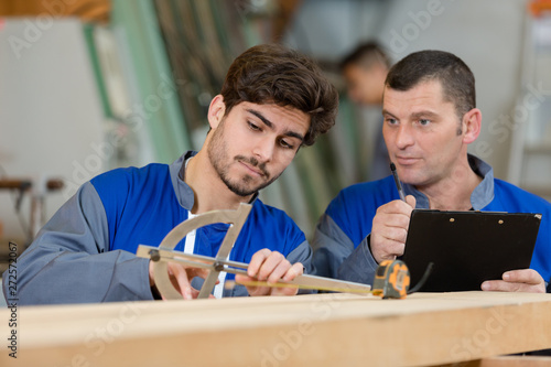 carpenters measuring wood