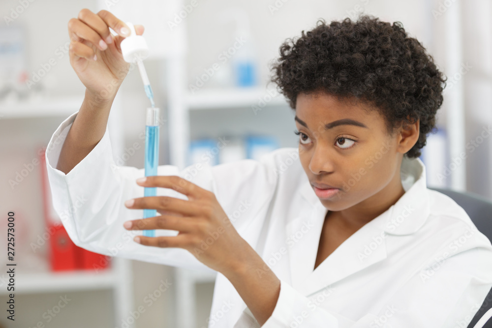 young female scientist witha pipette in the laboratory young female scientist witha pipette in the laboratory